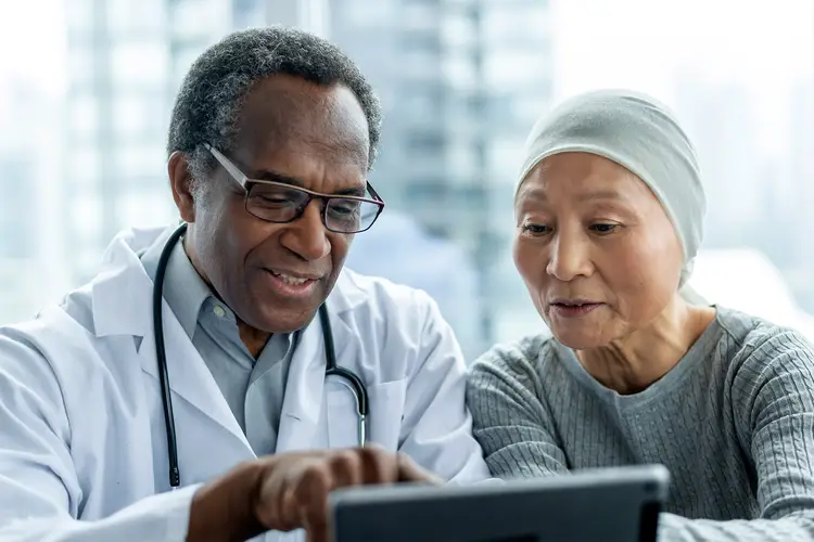 photo of doctor showing cancer patient test result